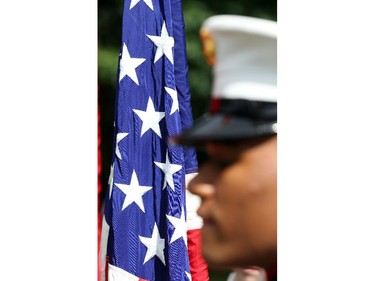 A US Marine stands in front of an American flag during the annual Fourth of July Independence Day celebration at the US Ambassador's residence in Ottawa, July 04, 2014.