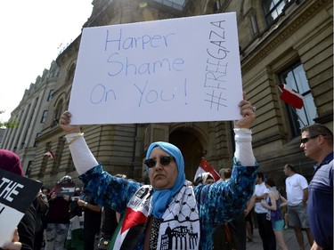 A woman protests in front of the Langevin Block in support of Palestinians in Gaza in Ottawa on Tuesday, July 22, 2014.