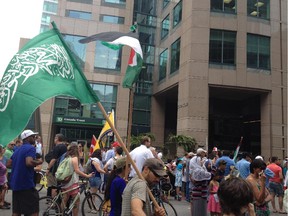 Adam John stands with a Hamas flag, which he says he was holding as a Muslim flag. It caused a social media stir after Tuesday's Palestinian protest in downtown Ottawa.