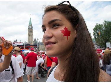 Alanna Ward from Vancouver sports a fresh maple leaf on her cheek as people flock to Parliament Hill and the downtown core to enjoy Canada's 147th birthday.