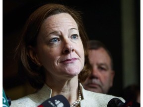 Alberta Premier Alison Redford meets with media following a meeting of the provincial PC Party executive in Calgary, Alta., Saturday, March 15, 2014. CBC News is reporting that Alberta's auditor general found "false passengers" were booked on some government flights so that then-premier Redford could fly alone.