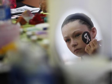 Amelie Contant has her face painted before the Redblacks' home opener against the Toronto Argonauts at TD Place on Friday, July 18, 2014.