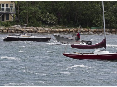 A boater heads to dock in Mahone Bay near Oakland, N.S. on Saturday, July 5, 2014. Thousands of homes and businesses were without power as heavy rains and high winds from tropical storm Arthur buffeted the region.