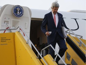 US Secretary of State John Kerry leaves his plane at Vienna International Airport as he arrives for talks with foreign ministers from the six powers negotiating with Tehran on its nuclear program in Vienna, July 13, 2014.  Kerry arrived in the early hours after clinching a deal in Kabul with Afghanistan's presidential candidates to end the country's election crisis.