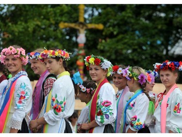 Young women in traditional dress take part in an international potters festival in the Belarusian village of Gorodnaya, some 360 km south-west of Minsk, on July 27, 2014. The village is famous for its potters.