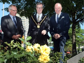 Belgian Ambassador Bruno van der Pluijm, left, and the governor of East Flanders, Jan Briers, stand with Mayor Jim Watson in front of city hall on Monday after Ottawa was presented with 144 rose bushes to mark the 200th anniversary of the signing of the Treaty of Ghent, which formally ended the War of 1812. So far, Watson has had to devote little time to his re-election campaign due to the lack of serious challengers.