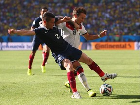 Mathieu Debuchy of France and Mario Goetze of Germany compete for the ball during the 2014 FIFA World Cup Brazil Quarter Final match between France and Germany at Maracana on July 4, 2014 in Rio de Janeiro, Brazil.