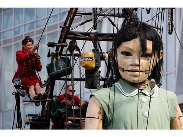 LIVERPOOL, ENGLAND - JULY 27:  The Little Giant Girl walks through Liverpool as she takes part in Liverpool's World War I centenary commemorations on July 27, 2014 in Liverpool, England. French street theatre company Royal de Luxe put on a show throughout the city from July 23-27. The giant puppet grandmother slept in St George's Hall for two days as part of 'Memories of August 1914'. As the giants tour the city the Little Girl Giant and her dog Xolo tell the story of the Liverpool Pals, the voluntary battalions from the city who served in WW1.