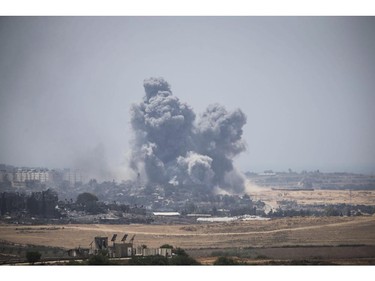 ISRAEL/GAZA BORDER, ISRAEL - JULY 27:  Smoke rises from Gaza Strip after Israeli shelling moment before the 24 hour ceasefireon July 27, 2014 on the Israeli/Gaza border, Israel.42 Israeli soldiers and over 1,000 Palestinians have been killed as the Israeli operation 'Protective Edge' nears three weeks.