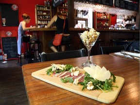 Some duck prosciutto and a view of the bar at Bistro CoqLicorne in Hull (Jean Levac / Ottawa Citizen)