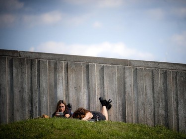 Bluesfest fans take a rest on the hill outside of the Canadian War Museum Sunday July 6, 2014.