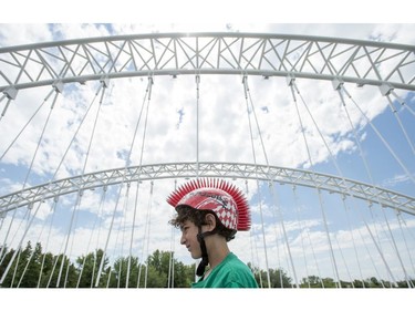 Brayden Goldberg, 10, stands on the bridge deck during the opening of the Strandherd-Armstrong Bridge in Ottawa on Saturday, July 12, 2014. The bridge connects the communities of Barrhaven and Riverside South over the Rideau River.