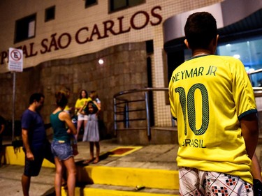 FORTALEZA, BRAZIL - JULY 04:  Brazil football fan stay outside Sao Carlos Hospital where superstar striker Neymar was treated after being injured during the quarter-final football match between Brazil and Colombia at the Castelao Stadium in Fortaleza during the 2014 FIFA World Cup on July 4, 2014. Brazil star Neymar was ruled out of the World Cup after that with a back injury, team doctor Rodrigo Lasmar said. Lasmar told reporters Neymar suffered a fracture in the third verterbra of his back during Brazil's bruising 2-1 quarter-final victory over Colombia.