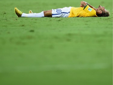 FORTALEZA, BRAZIL - JULY 04:  Neymar of Brazil lies on the field after a challenge during the 2014 FIFA World Cup Brazil Quarter Final match between Brazil and Colombia at Castelao on July 4, 2014 in Fortaleza, Brazil.
