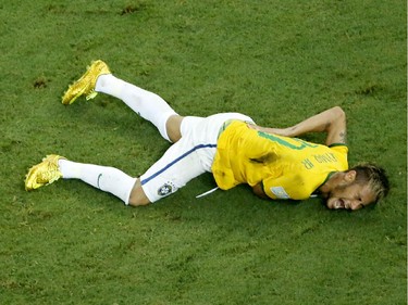 Brazil's Neymar grimaces in pain after getting injured during the World Cup quarterfinal soccer match between Brazil and Colombia at the Arena Castelao in Fortaleza, Brazil, Friday, July 4, 2014.