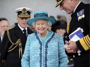 In this Ministry of Defence handout picture Queen Elizabeth II and Prince Philip, The Duke of Edinburgh (L) in a ship naming ceremony conducted at Rosyth Dockyard in Rosyth, Scotland on July 4, 2014.
