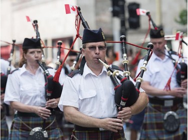 A piped band entertains the crowd during the annual Canada Day parade in Montreal, Tuesday, July 1, 2014.