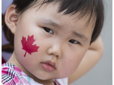A young girl enjoys the festivities during the annual Canada Day parade in Montreal, Tuesday, July 1, 2014.
