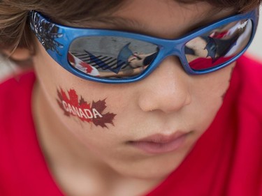 A young boy enjoys the festivities during the annual Canada Day parade in Montreal, Tuesday, July 1, 2014. THE CANADIAN PRESS/Graham Hughes