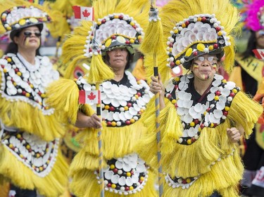 Participants entertain the crowd during the annual Canada Day parade in Montreal, Tuesday, July 1, 2014.