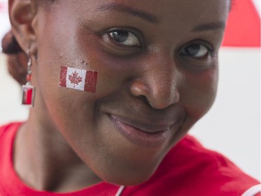 A woman enjoys the festivities during the annual Canada Day parade in Montreal, Tuesday, July 1, 2014.