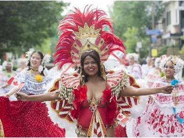 Participants entertain the crowd during the annual Canada Day parade in Montreal, Tuesday, July 1, 2014.