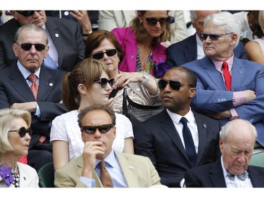 Canada's High Commissioner to London Gordon Campbell, top right, and former International Olympic Committee President Jacques Rogge, top left, sit in the Royal Box on centre court with British actor Chiwetel Ejiofor, center right, and Sari Mercer, center left,  prior to the women's singles final between Eugenie Bouchard of Canada and Petra Kvitova of the Czech Republic at the All England Lawn Tennis Championships in Wimbledon, London, Saturday July 5, 2014.