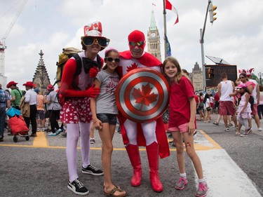 Captain Canada and his sidekick pose on Wellington Street as people flock to Parliament Hill and the downtown core to enjoy Canada's 147th birthday.