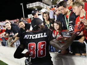Carlton Mitchell of the Ottawa Redblacks celebrates his team's first win at the franchise home opener against the Toronto Argonauts at TD Place in Ottawa, July 18, 2014.