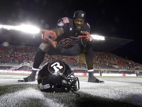 Ottawa Redblacks Carlton Mitchell poses with his helmet.