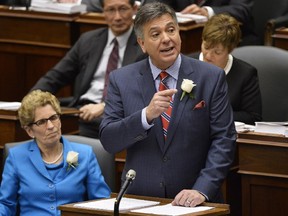 Ontario Finance Minister Charles Sousa, right, delivers the 2014 budget next to Premier Kathleen Wynne at Queen's Park in Toronto on Thursday, May 1, 2014.THE CANADIAN PRESS/Nathan Denette