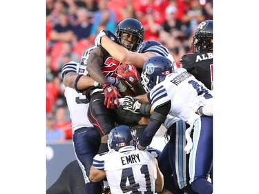 Chevon Walker of the Ottawa Redblacks is tackled by the Toronto Argonauts at TD Place in Ottawa during the franchise home opener of the Redblacks on Friday, July 18, 2014.