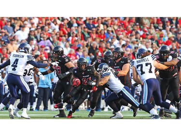 Chevon Walker of the Ottawa Redblacks splits the defines of the Toronto Argonauts at TD Place in Ottawa during the franchise home opener of the Redblacks on Friday, July 18, 2014.