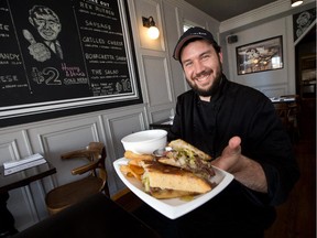 Cody Starr, chef at The Rex on Adeline St in Little Italy, with "The Rex Reuben." (Wayne Cuddington/Ottawa Citizen)