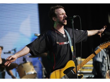 Colin MacDonald of the Trews wore his Redblacks jersey while playing a pre-game concert on the stadium grounds before the Redblacks' home opener at TD Place on Friday, July 18, 2014.