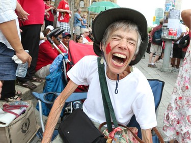 Constance Snelgrove gets into the spirit of the day by having a maple leaf painted on her cheek as people flock to Parliament Hill and the downtown core to enjoy Canada's 147th birthday.