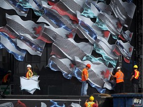 Crews work on dismantling the stage on Parliament Hill in Ottawa, following yesterday's Canada Day celebrations on July 2, 2014. (Cole Burston/Ottawa Citizen)
