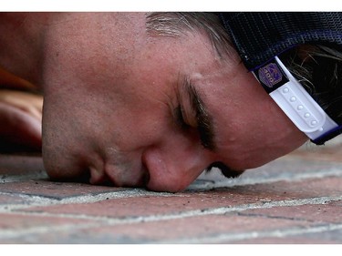 INDIANAPOLIS, IN - JULY 27:  Jeff Gordon, driver of the #24 Axalta Chevrolet, celebrates by kissing the bricks after winning the NASCAR Sprint Cup Series Crown Royal Presents The John Wayne Walding 400 at the Brickyard Indianapolis Motor Speedway on July 27, 2014 in Indianapolis, Indiana.