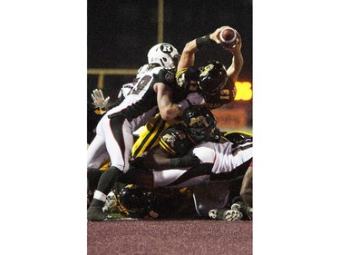 Hamilton Tiger-Cats quarterback Dan LeFevour, right, stretches to score the game-winning touchdown late in the fourth quarter to defeat the Ottawa Redblacks in their CFL home opener in Hamilton, Ont., Saturday, July 26, 2014.