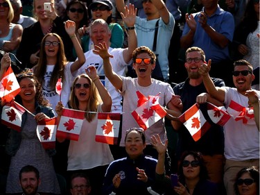 Canadian fans watch Milos Raonic of Canada in action during his Gentlemen's Singles fourth round match against Kei Nishikori of Japan on day eight of the Wimbledon Lawn Tennis Championships at the All England Lawn Tennis and Croquet Club on July 1, 2014 in London, England.