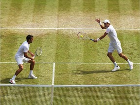 Nenad Zimonjic of Serbia (l) and Daniel Nestor of Canada during their Gentlemen's Doubles Quarter-Final match against Radek Stepanek of Czech Republic and Leander Paes of India on day ten of the Wimbledon Lawn Tennis Championships at the All England Lawn Tennis and Croquet Club on July 3, 2014 in London, England.