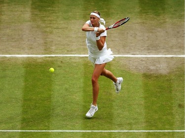 Petra Kvitova of Czech Republic plays a backhand return during the Ladies' Singles final match against Eugenie Bouchard of Canada on day twelve of the Wimbledon Lawn Tennis Championships at the All England Lawn Tennis and Croquet Club on July 5, 2014 in London, England.