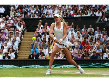 Eugenie Bouchard of Canada plays a backhand return during the Ladies' Singles final match against Petra Kvitova of Czech Republic on day twelve of the Wimbledon Lawn Tennis Championships at the All England Lawn Tennis and Croquet Club on July 5, 2014 in London, England.
