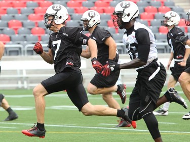 DB Eric Fraser, centre, rockets ahead of his teammates on a drill as the Ottawa Redblacks have their first practice at home since losing their opening season game against Winnipeg.