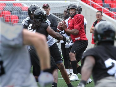 Despite oncoming traffic, QB Henry Burris throws calmly as the Ottawa Redblacks practice at TD Place Stadium at Lansdowne Park on Monday, July 14, 2014.