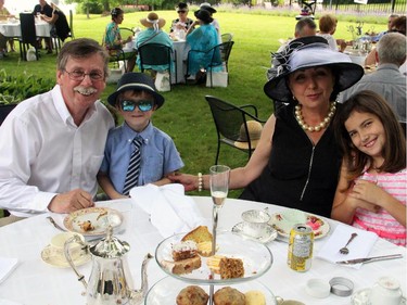 Don Walsh and Robin Stewart, seen with grandchildren Brady and Danika, hosted their second annual High Tea for Ryan's Well Foundation at their beautiful waterfront home in Plaisance, Que. on Sunday, July 20, 2014.