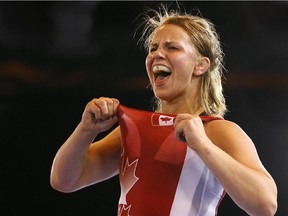 Stittsville wreslter Erica Wiebe celebrates winning gold in a bout against Jyoti of India on Tuesday, July 29, 2014 at the Commonwealth Games in Glasgow.