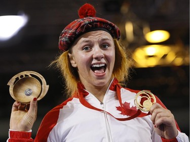 Erica Wiebe celebrates after beating Jyoti of India in the gold-medal match.