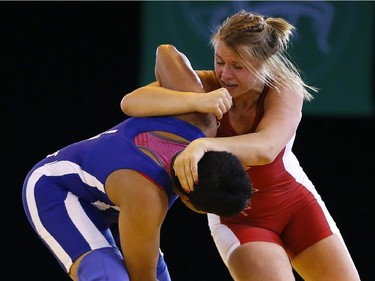 Erica Wiebe goes to the attack against Jyoti of India on Tuesday, July 29, 2014 at the Commonwealth Games.
