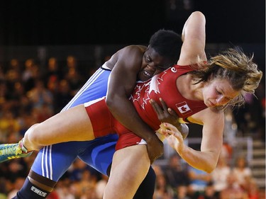 Erica Wiebe of Stittsville, right, wrestles with Blessing Onyebuchi of Nigeria on Tuesday, July 29, 2014 at the Commonwealth Games in Glasgow.